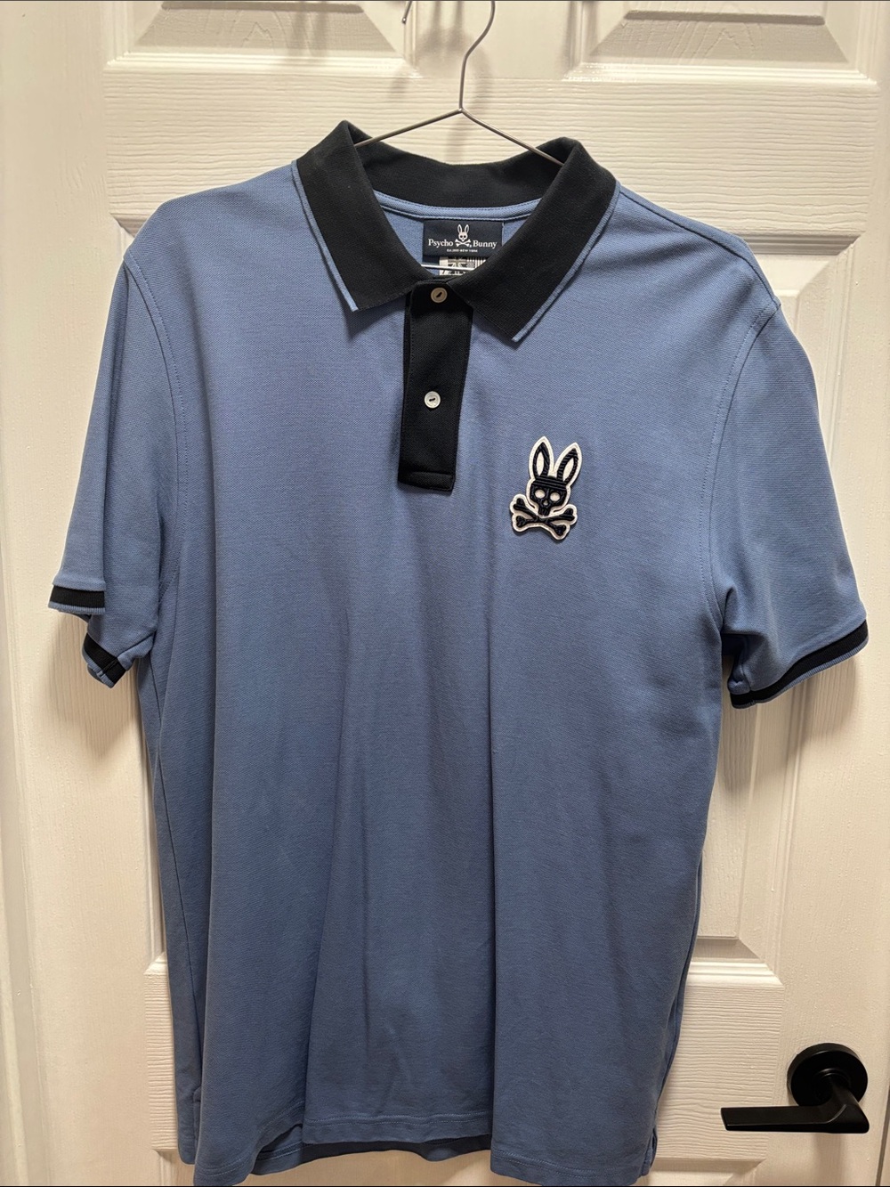 Psycho Bunny Light Blue Polo with Black Collar & Trim has tiny pull